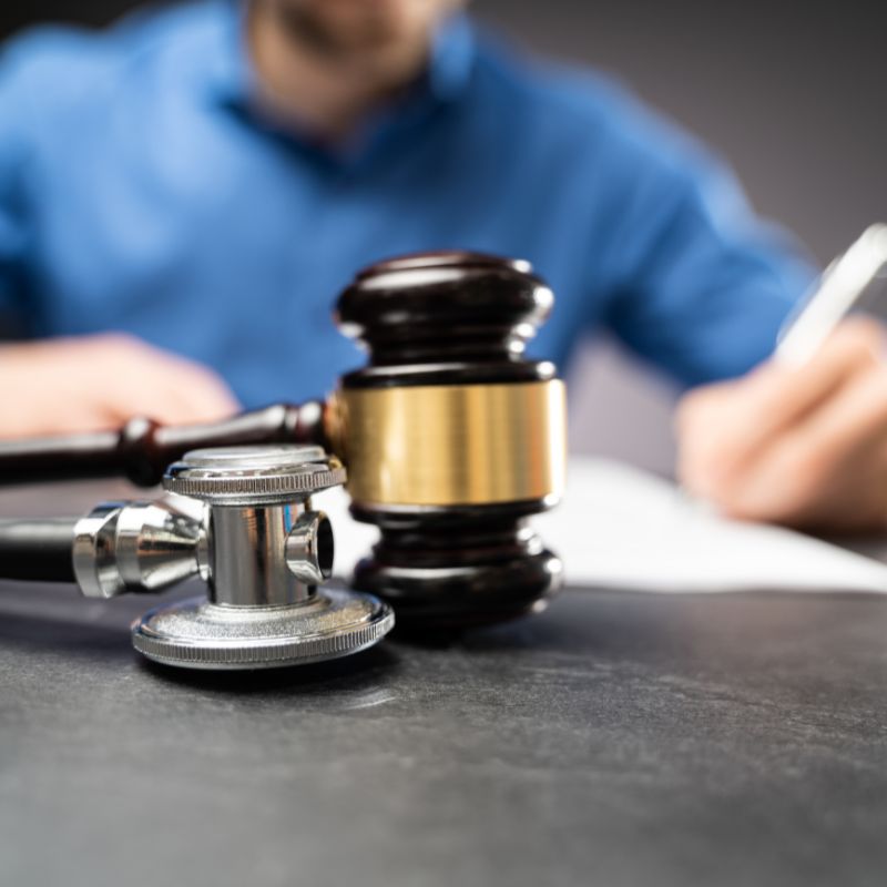 a gavel and stethoscope on a desk